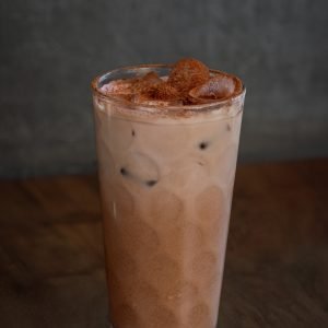 A chilled glass of iced chocolate, served over ice with a creamy, rich cocoa flavor.