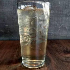 Iced tea infused with ginger, lemon, and peppermint, served over ice for a cool, invigorating drink.