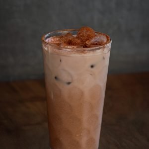 A refreshing glass of iced mocha, with a perfect blend of chilled espresso, chocolate syrup, and milk.