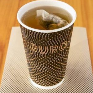 A calming cup of organic peppermint tea, with vibrant green leaves and a refreshing minty aroma.