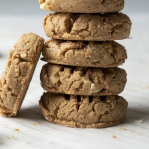 A freshly baked Vegan Cashew Cookie, filled with whole cashews and a hint of vanilla, providing a satisfying plant-based snack.